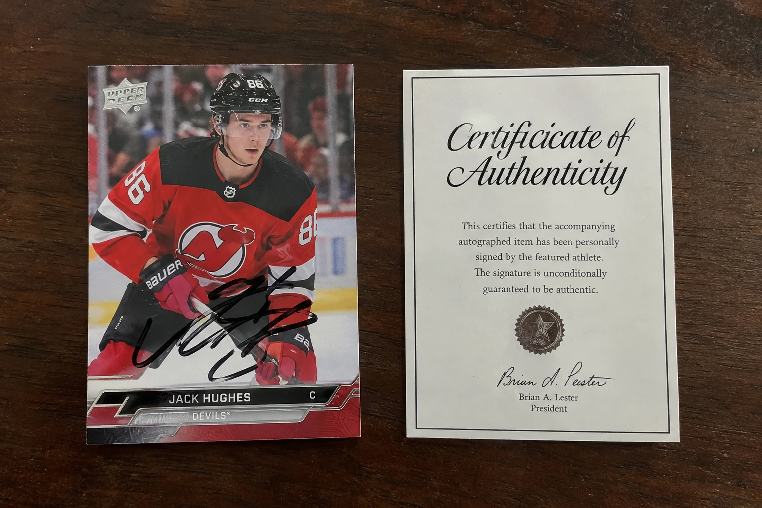 A signed trading card with a certificate being graded