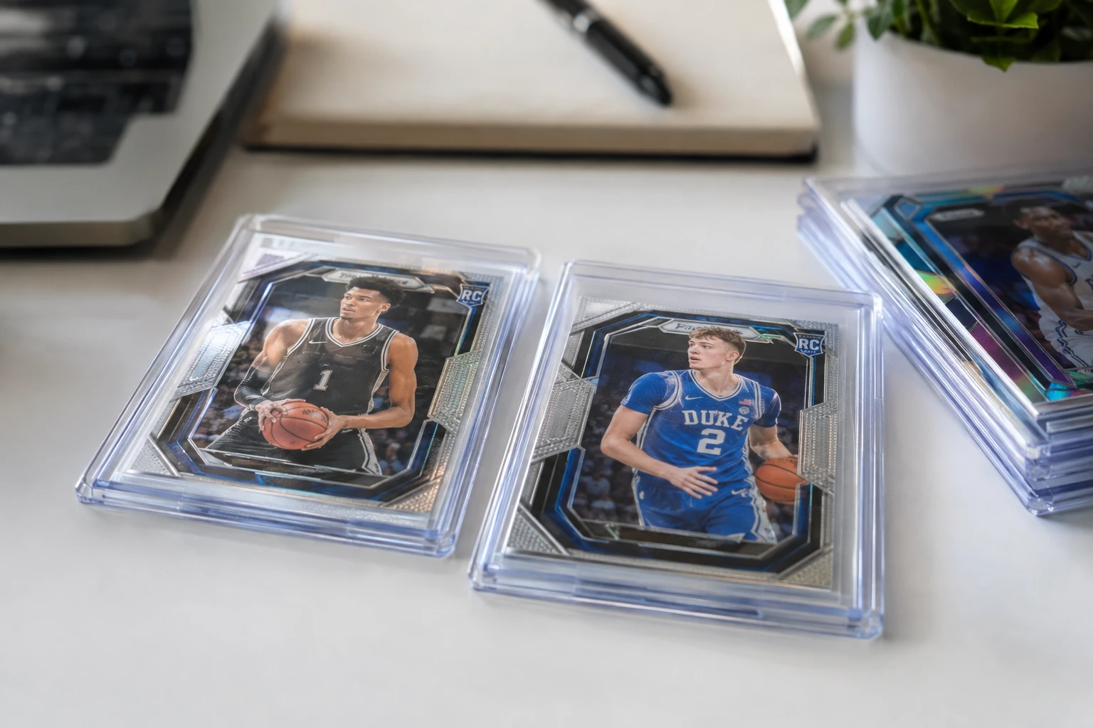 Panini Prizm basketball rookie cards of Wembanyama and Cooper Flagg laid out for AI grading