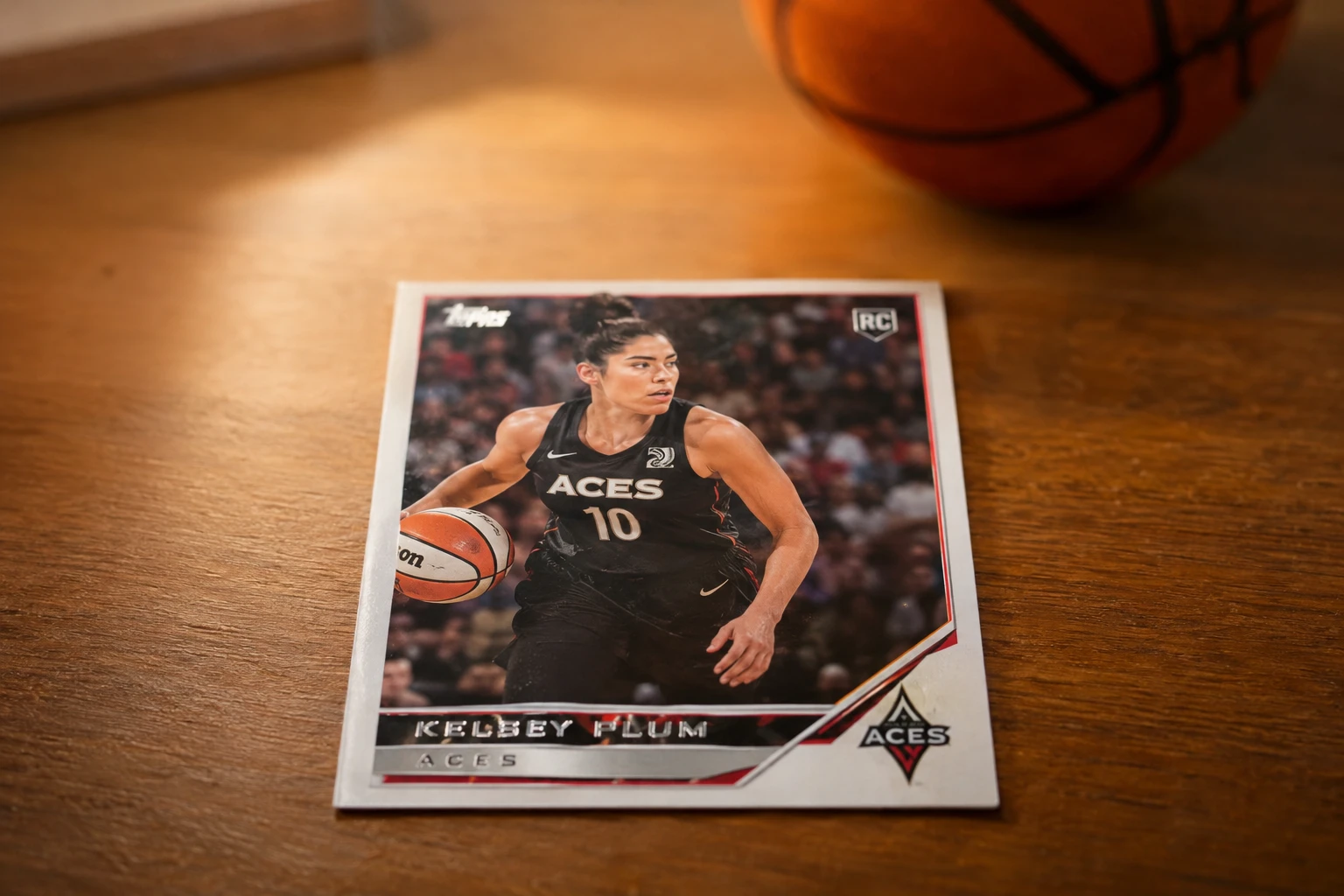 A Caitlin Clark basketball trading card being graded by a phone scanner