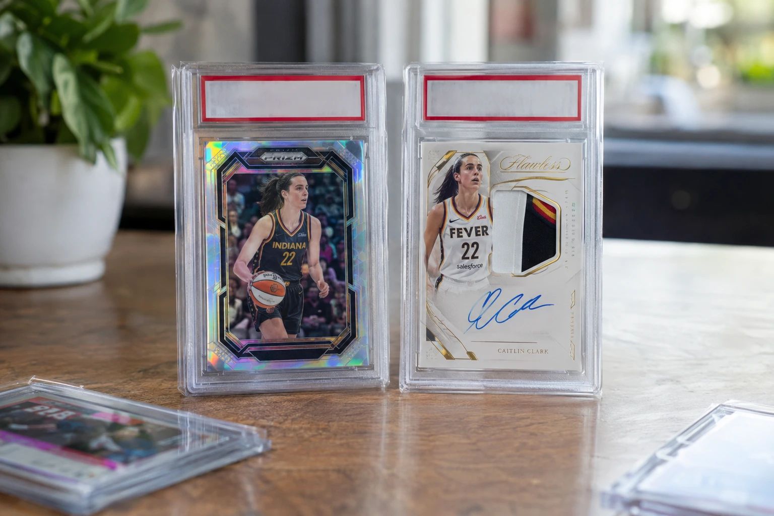 Caitlin Clark Panini Prizm and Flawless WNBA rookie cards displayed for PSA grading