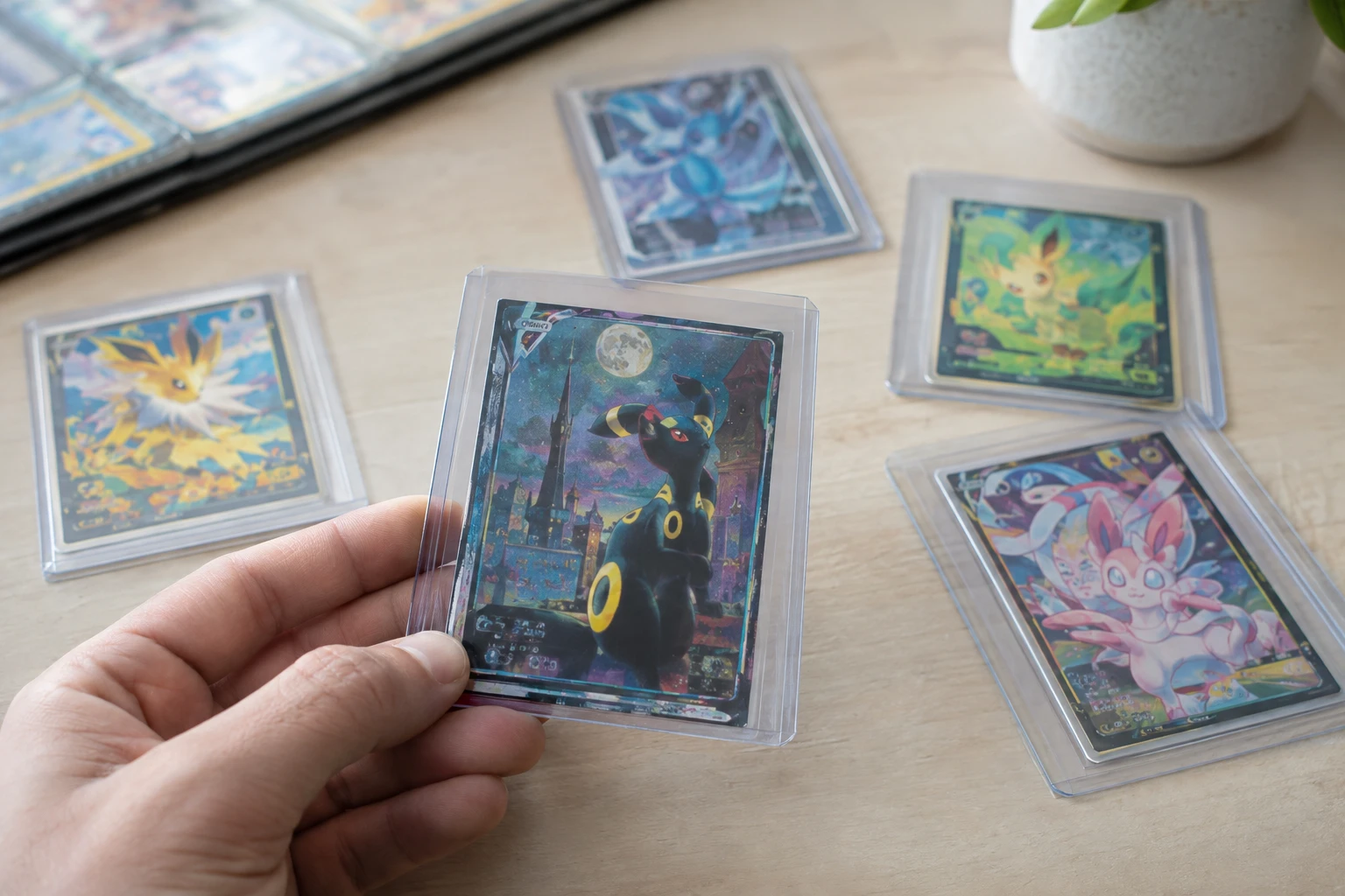 Pokemon Evolving Skies trading cards featuring Umbreon and Eeveelution artwork on a collector's display table