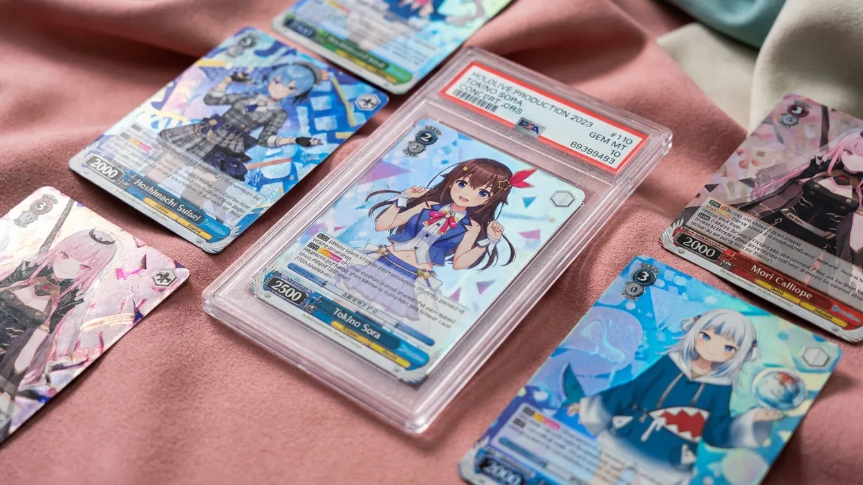 hololive Official Card Game cards with anime idol character art including SEC signed cards laid out for AI grading