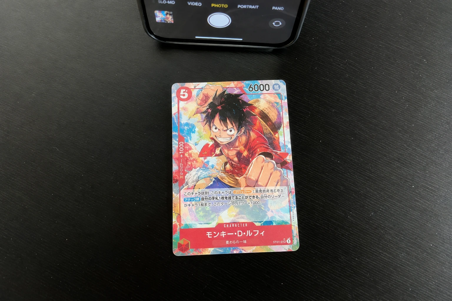 A Digimon trading card being scanned for AI grading
