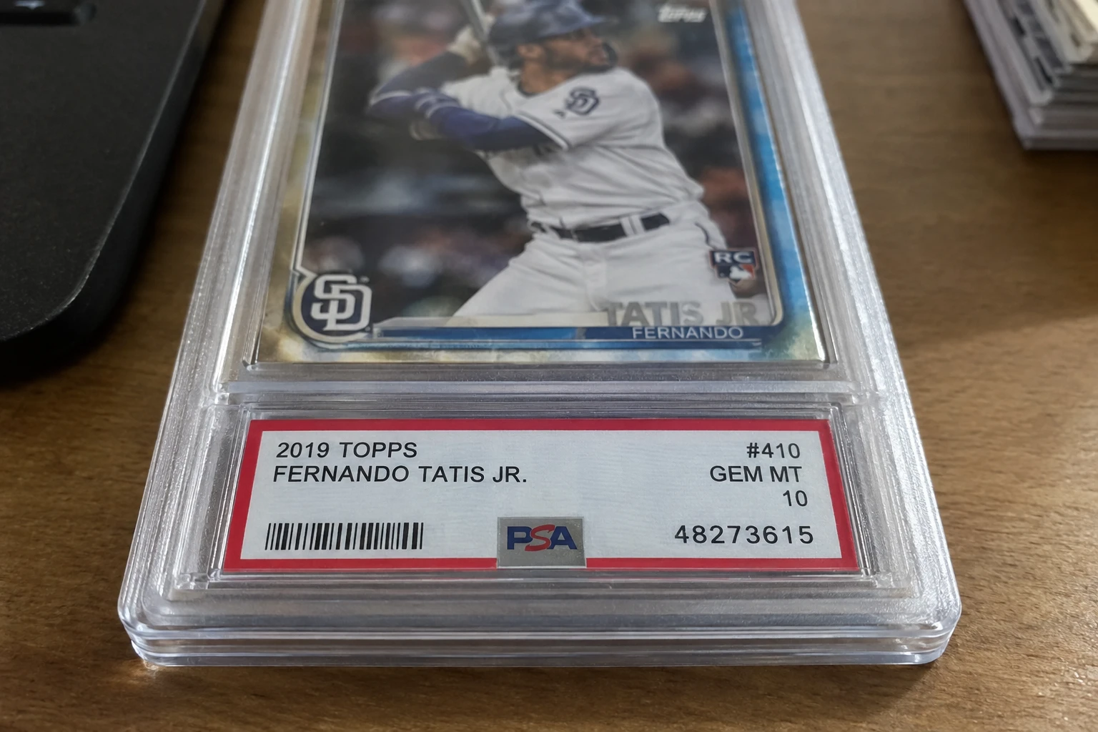 Close-up of a PSA graded card slab showing the certification barcode and number on the label