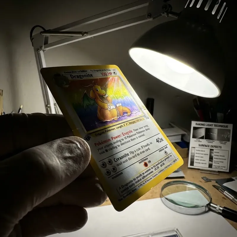 Card under raking light revealing hidden surface wrinkle