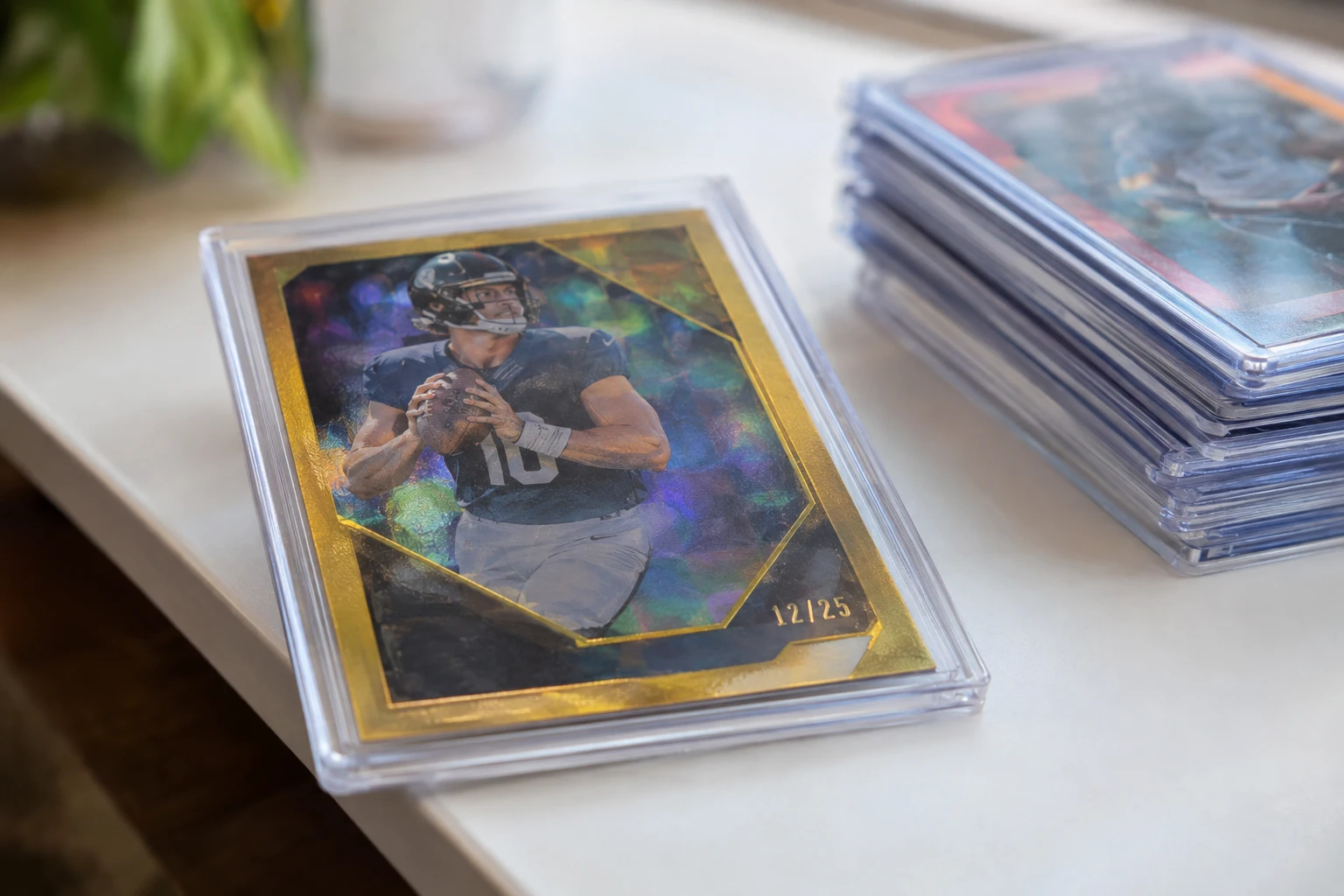 Close-up of a serial-numbered parallel sports card showing the stamped number in gold foil