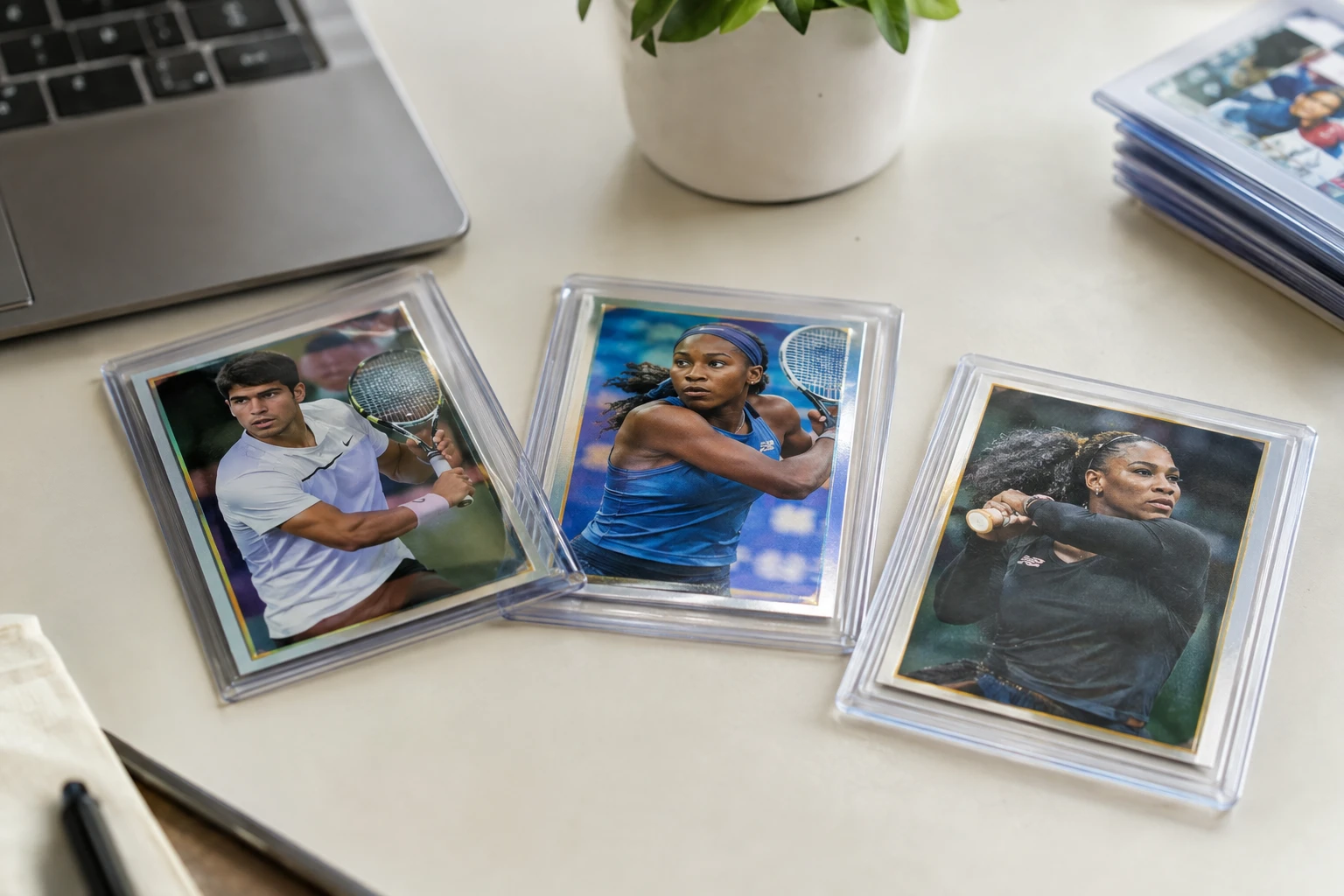Tennis trading cards featuring Carlos Alcaraz, Coco Gauff, and Serena Williams laid out for AI grading analysis
