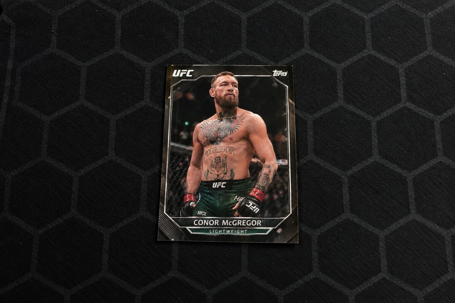 A UFC trading card being graded by a phone scanner