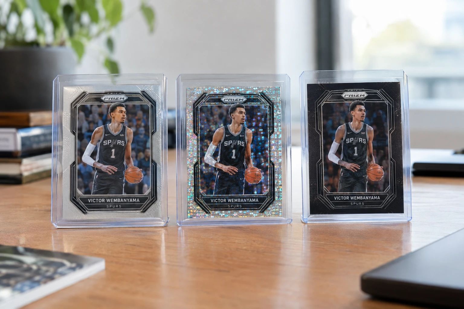 Victor Wembanyama Panini Prizm basketball cards including base, White Sparkle, and Black 1/1 parallels displayed for grading